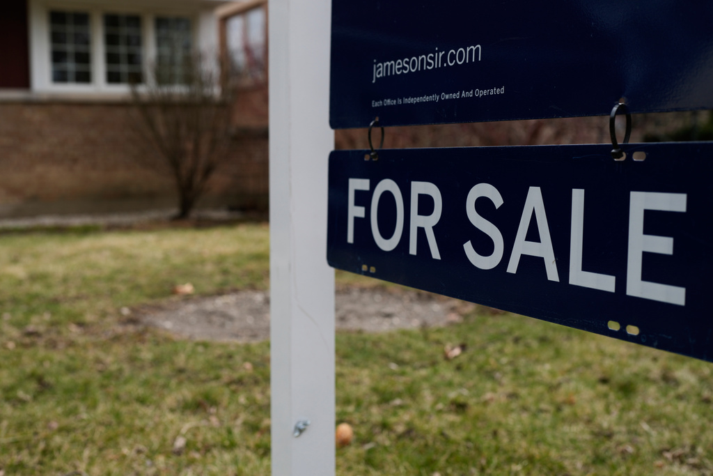 A House For Sale sign is displayed in front of a home in Evanston, Ill.,Wednesday, March 25, 2026. (AP Photo/Nam Y. Huh)