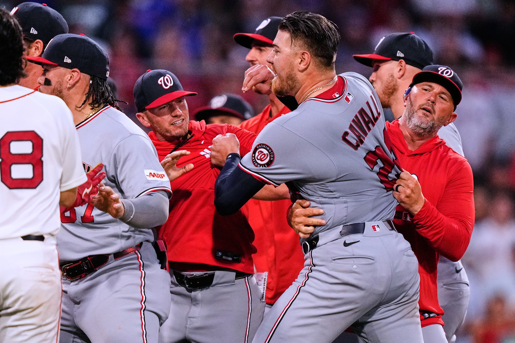 Washington Nationals' Cade Cavalli, front right, is held back as tempers flare during the fourth inning of a baseball game against the Boston Red Sox, Tuesday, June 30, 2026, in Boston. (AP Photo/Charles Krupa)