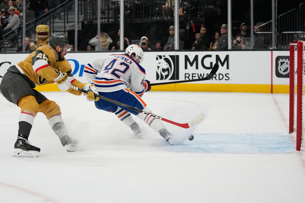 Edmonton Oilers right wing Kasperi Kapanen (42) scores on an open net against the Vegas Golden Knights during the third period of an NHL hockey game Sunday, March 8, 2026, in Las Vegas. (AP Photo/John Locher)