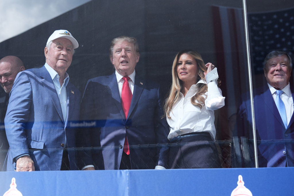 Dana White, UFC president and CEO, from left, Roger Penske, President Donald Trump, first lady Melania Trump and Viktor Knavs watch after Kyle Kirkwood (27) won the IndyCar Freedom 250 Grand Prix auto race in Washington, Sunday, Aug. 23, 2026. (AP Photo/Alex Brandon)