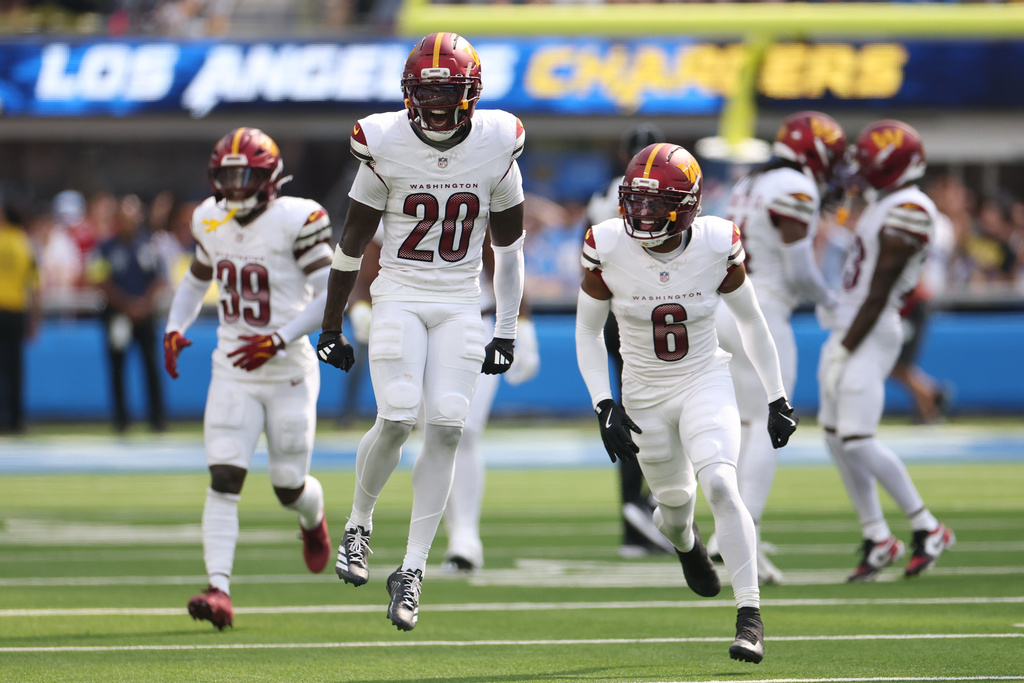 The Washington Commanders celebrates after recovering a fumble by Los Angeles Chargers wide receiver Quentin Johnston during the first half of an NFL football game Sunday, Oct. 5, 2025, in Inglewood, Calif. (AP Photo/Eric Thayer)