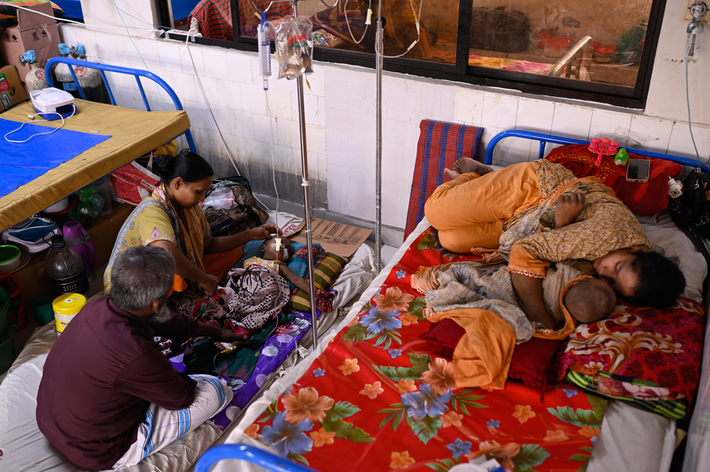Families take care of their children receiving treatment for measles at the Infectious Diseases Hospital in Dhaka, Bangladesh, Monday, April 6, 2026, amid a countrywide outbreak. (AP Photo/Mahmud Hossain Opu)