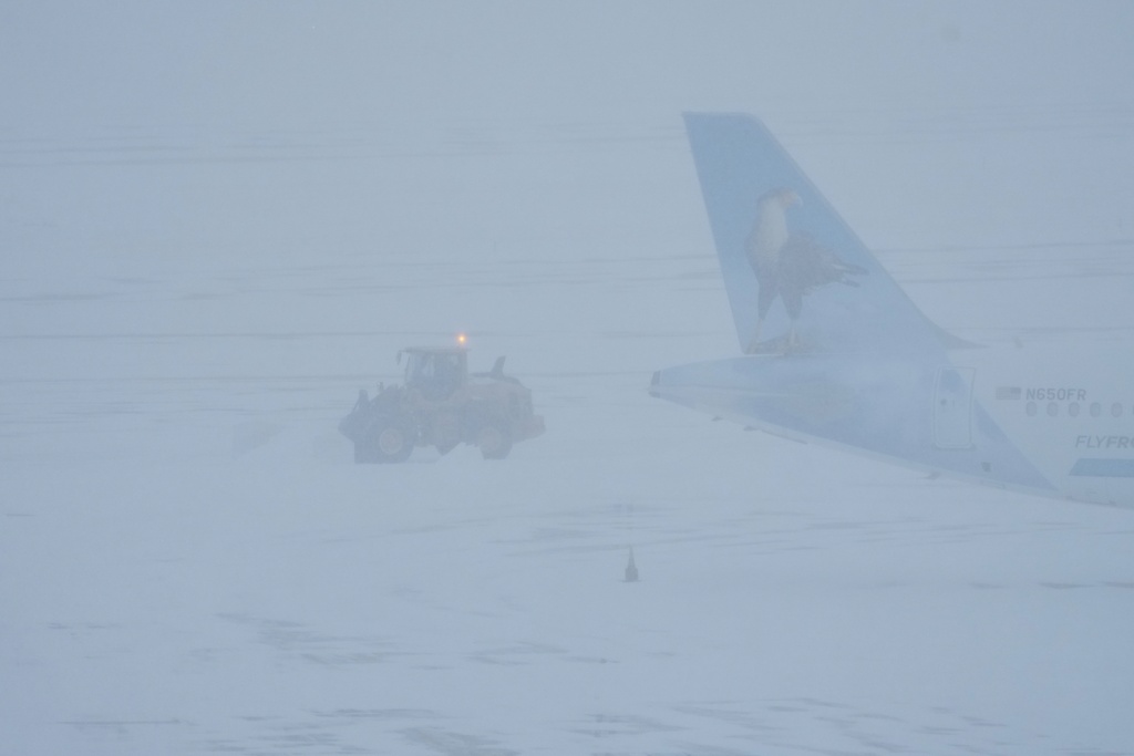Airport crew plow snow during a winter storm in Philadelphia, Sunday, Jan. 25, 2026. (AP Photo/Matt Rourke)