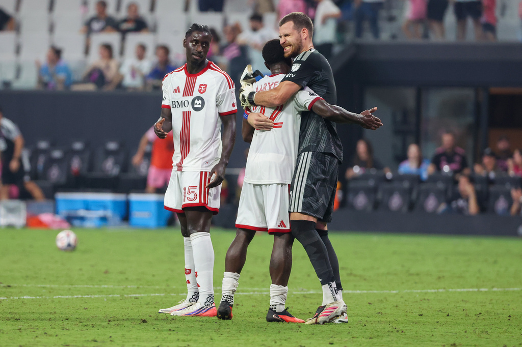 Toronto FC goalkeeper Luka Gavran (1) defenders Richie Laryea (22) and Nicksoen Gomis (15) celebrate after defeating Inter Miami in an MLS soccer game on Saturday, Aug. 22, 2026, in Miami. (AP Photo/David Santiago)
