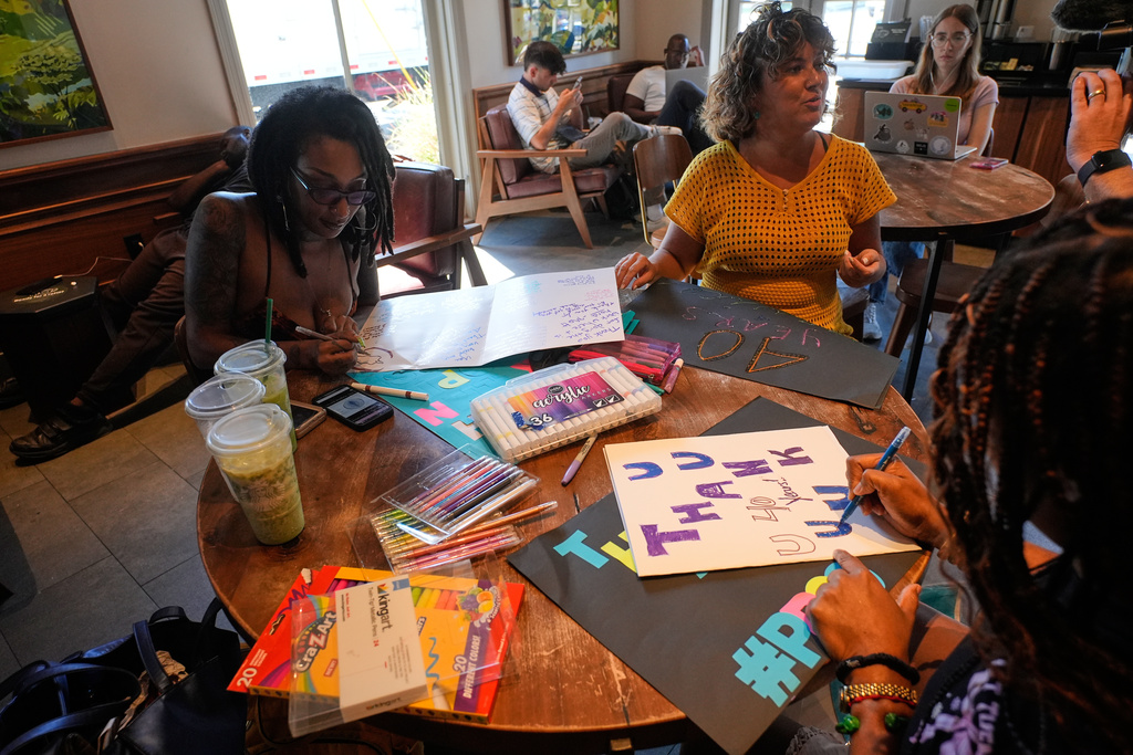 Members of Louisiana Coalition for Reproductive Freedom compose thank you cards and well wishes at a coffee shop to deliver to Planned Parenthood on the day they are closing, in New Orleans, Tuesday, Sept. 30, 2025. (AP Photo/Gerald Herbert)