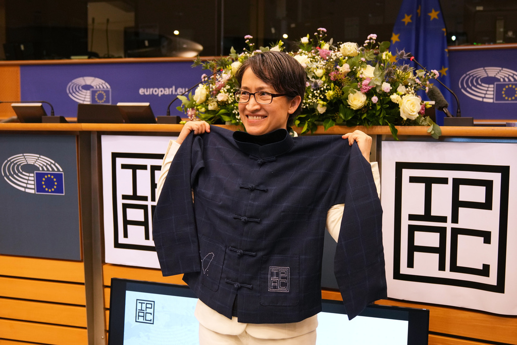 Taiwan's Vice President Bi-Khim Hsiao poses with a gift she received at the European Parliament in Brussels, Friday, Nov. 7, 2025. (AP Photo/Virginia Mayo)