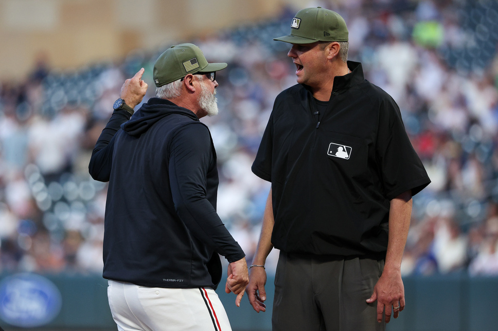 Minnesota Twins manager Derek Shelton, left, argues with umpire Jordan Baker after being ejected during the eighth inning of a baseball game against the Milwaukee Brewers, Friday, May 15, 2026, in Minneapolis. (AP Photo/Matt Krohn)