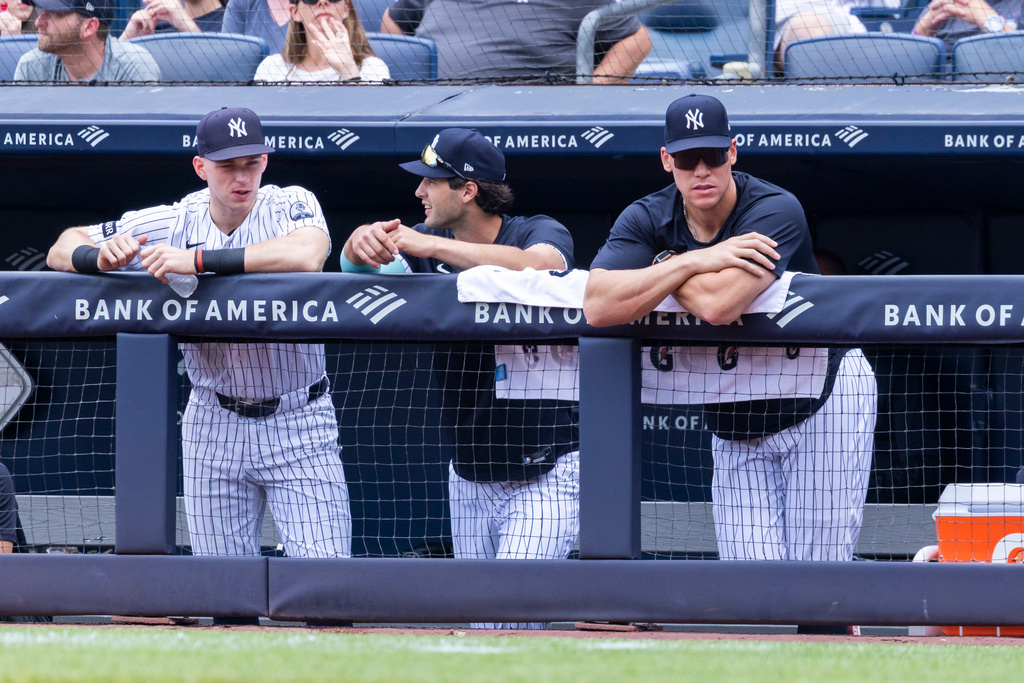 New York Yankees' Ben Rice, left, Spencer Jones, center, and Aaron Judge, right, lean on the dugout rail in the first inning during a baseball game against the Boston Red Sox, Sunday, Aug. 30, 2026, in New York. (AP Photo/Corey Sipkin)