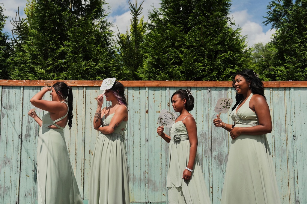 FILE - Bridesmaids use fans for shade and to keep cool during bridal pictures before a wedding Saturday, Aug. 23, 2025, in Newtown, Ohio. (AP Photo/Joshua A. Bickel, File)