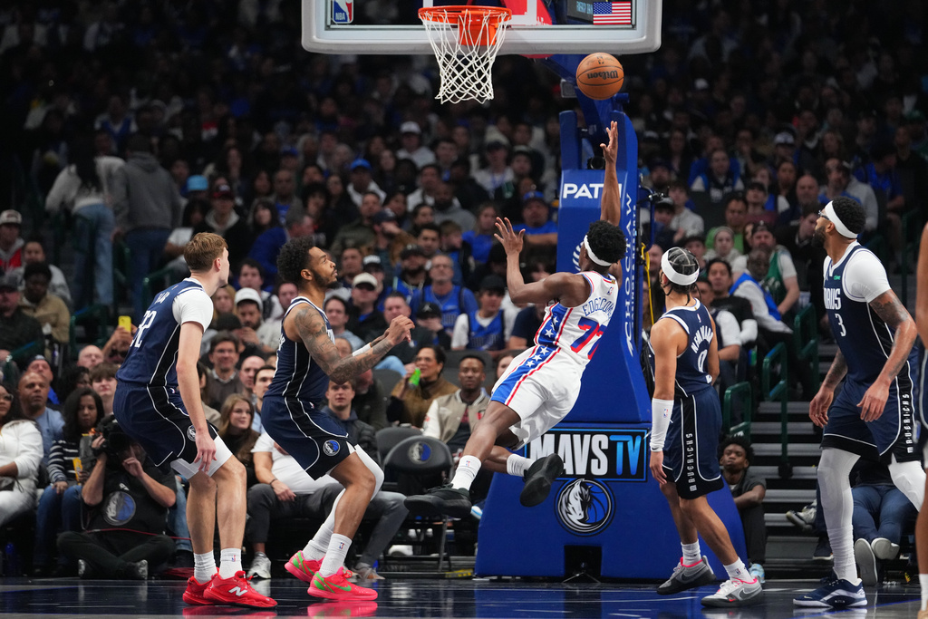 Philadelphia 76ers guard Vj Edgecombe (77) shoots the ball against the Dallas Mavericks during the first half of an NBA basketball game Thursday, Jan. 1, 2026, in Dallas. (AP Photo/Julio Cortez)