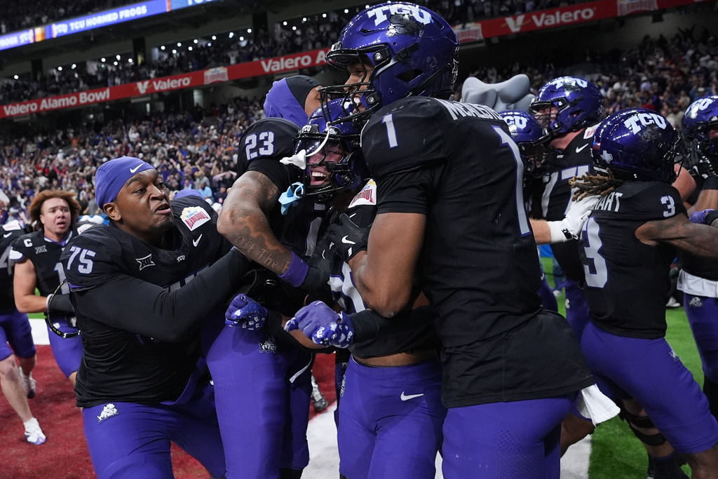 TCU running back Jeremy Payne, center, celebrates with teammates after he ran for a touchdown against Southern California during overtime in the Alamo Bowl NCAA college football game in San Antonio, Tuesday, Dec. 30, 2025. (AP Photo/Eric Gay)