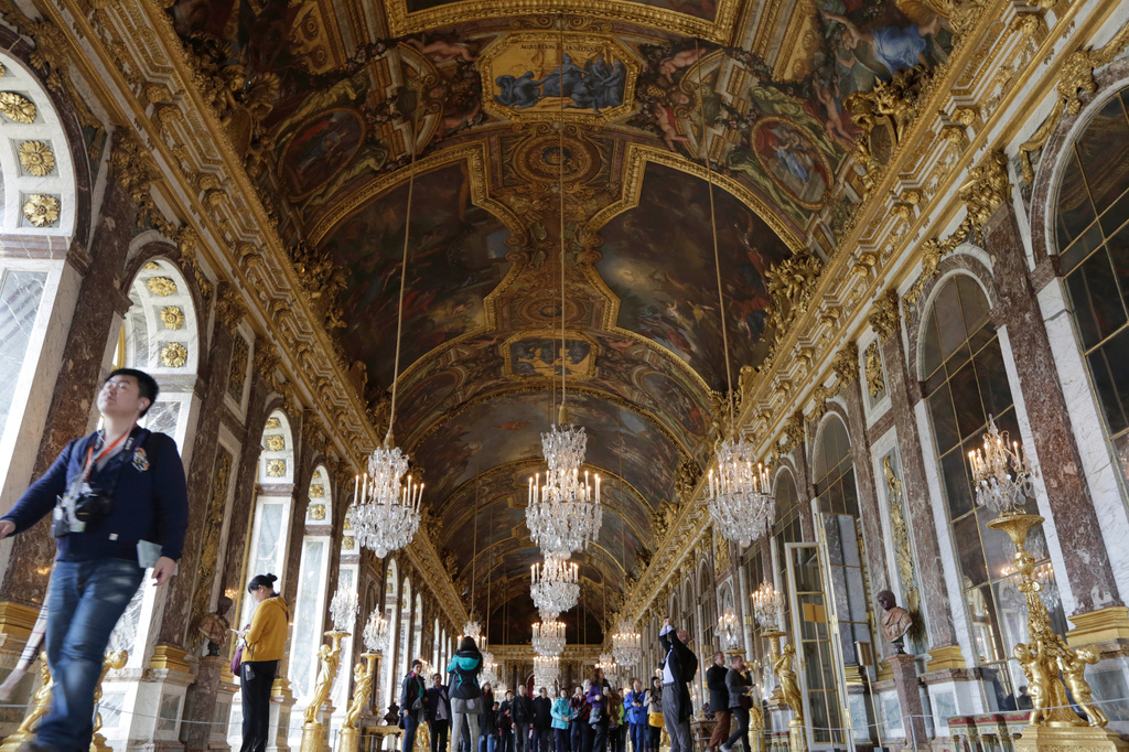 FILE - Visitors walk inside the Hall of Mirrors in the Versailles castle, on Nov. 17, 2015 in Versailles, west of Paris. (AP Photo/Amr Nabil, File)