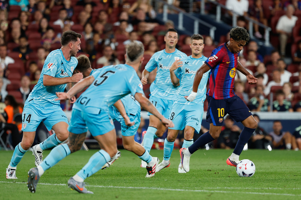 Barcelona's Lamine Yamal controls the ball surrounded by Athletic players during a Spanish La Liga soccer match between Barcelona and Athletic in Barcelona, Spain, Thursday, Aug. 27, 2026. (AP Photo/Joan Monfort)