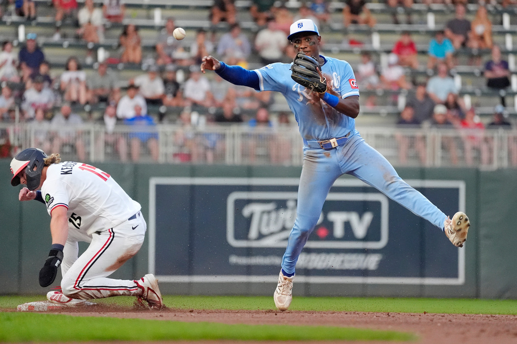 Kansas City Royals right fielder Tyler Tolbert, right, forces out Minnesota Twins' Luke Keaschall (15) but cannot turn the double play on a fielder's choice by Ryan Kreidler in the fifth inning of a baseball game Wednesday, July 29, 2026, in Minneapolis. (AP Photo/Bruce Kluckhohn)