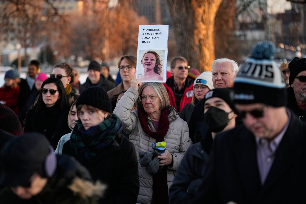 People gather for a vigil honoring Renee Good, who was fatally shot by an ICE officer in Minneapolis earlier in the week, at the Minnesota State Capitol in St. Paul, Minn., Friday, Jan. 9, 2026. (AP Photo/John Locher)
