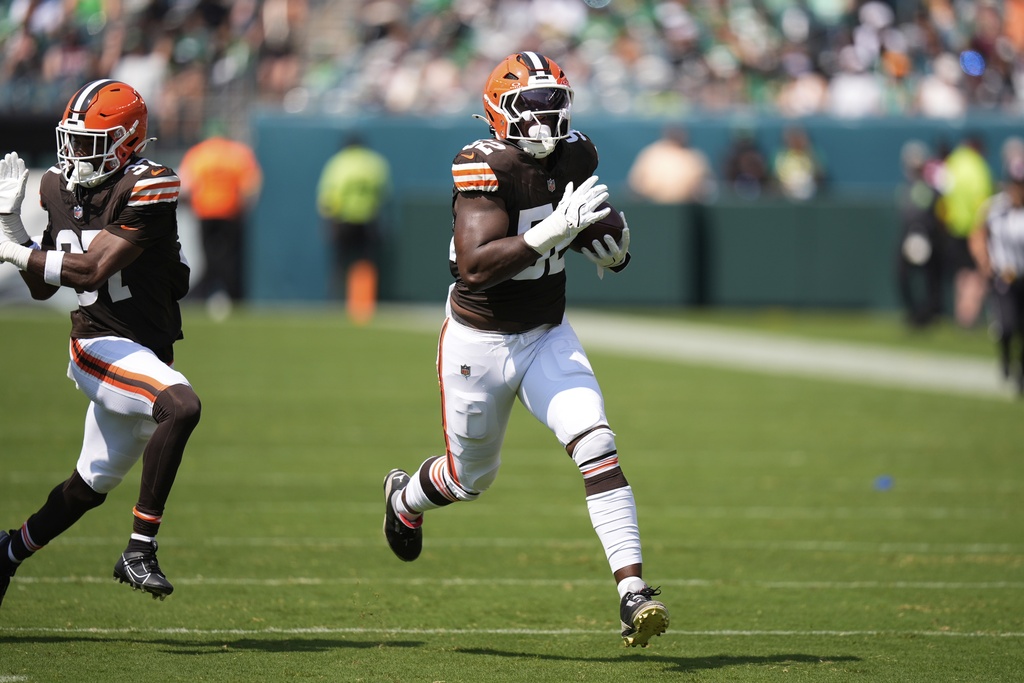 Cleveland Browns defensive end KJ Henry (52) runs for a touchdown after an interception during the second half of an NFL preseason football game against the Philadelphia Eagles on Saturday, Aug. 16, 2025, in Philadelphia.(AP Photo/Chris Szagola)