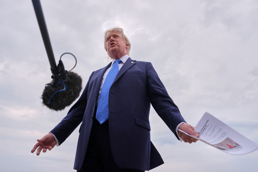 President Donald Trump speaks with reporters before boarding Air Force One, Friday, Aug. 14, 2026, at Joint Base Andrews, Md. (AP Photo/Julia Demaree Nikhinson)