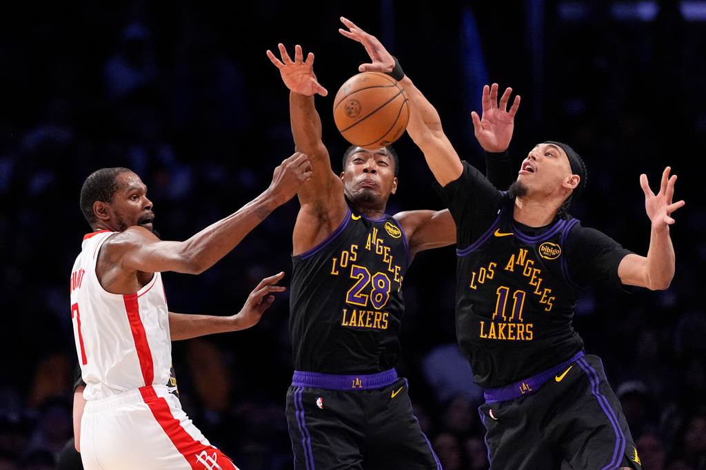 Houston Rockets forward Kevin Durant, left, passes as Los Angeles Lakers forward Rui Hachimura, center, and center Jaxson Hayes defend during the second half in Game 2 of a first-round NBA playoffs basketball series Tuesday, April 21, 2026, in Los Angeles. (AP Photo/Mark J. Terrill)