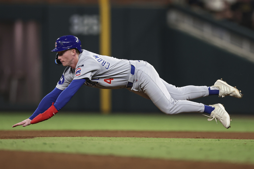 Chicago Cubs' Pete Crow-Armstrong (4) starts his slide during a steal attempt in the fifth inning of a baseball game against the Atlanta Braves, Tuesday, Sept. 9, 2025, in Atlanta. (AP Photo/Colin Hubbard)