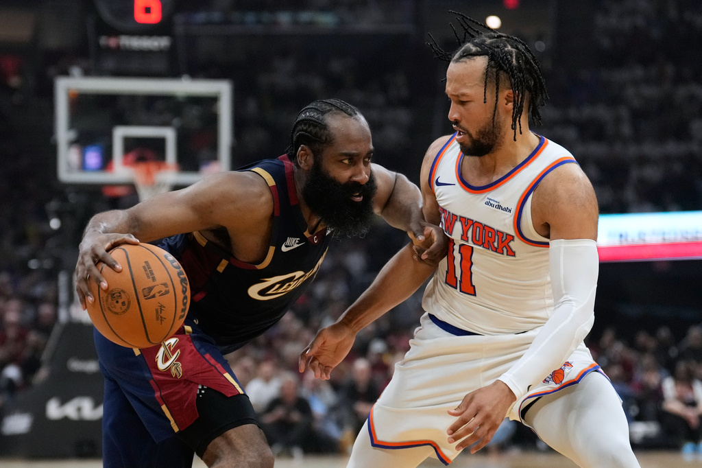 Cleveland Cavaliers guard James Harden (1) controls the ball against New York Knicks guard Jalen Brunson (11) during the second half of Game 3 in the Eastern Conference finals NBA basketball playoffs series in Cleveland, Saturday, May 23, 2026. (AP Photo/Sue Ogrocki)