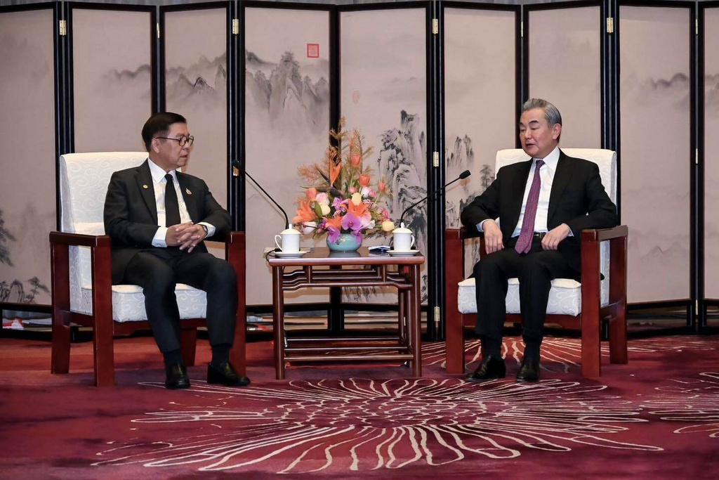 In this photo released by the Thai Ministry of Foreign Affairs, Thai Foreign Minister Sihasak Phuangketkeow, left, speaks with Wang Yi, Chinese Foreign Minister, during a meeting, in Yunnan Province, China, Sunday, Dec. 28, 2025. (Thai MFA via AP)