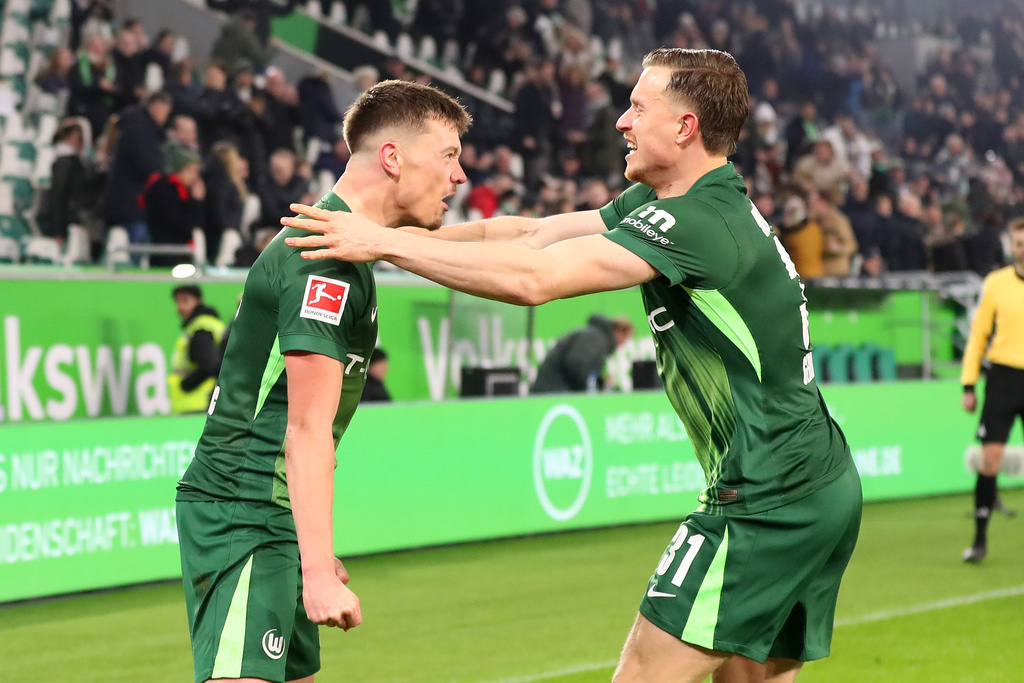 Wolfsburg's Dzenan Pejcinovic, left, celebrates with Yannick Gerhardt after scoring his side's second goal during the German Bundesliga soccer match between VfL Wolfsburg and SC Freiburg in Wolfsburg, Germany, Saturday, Dec. 20, 2025. (Darius Simka/dpa via AP)