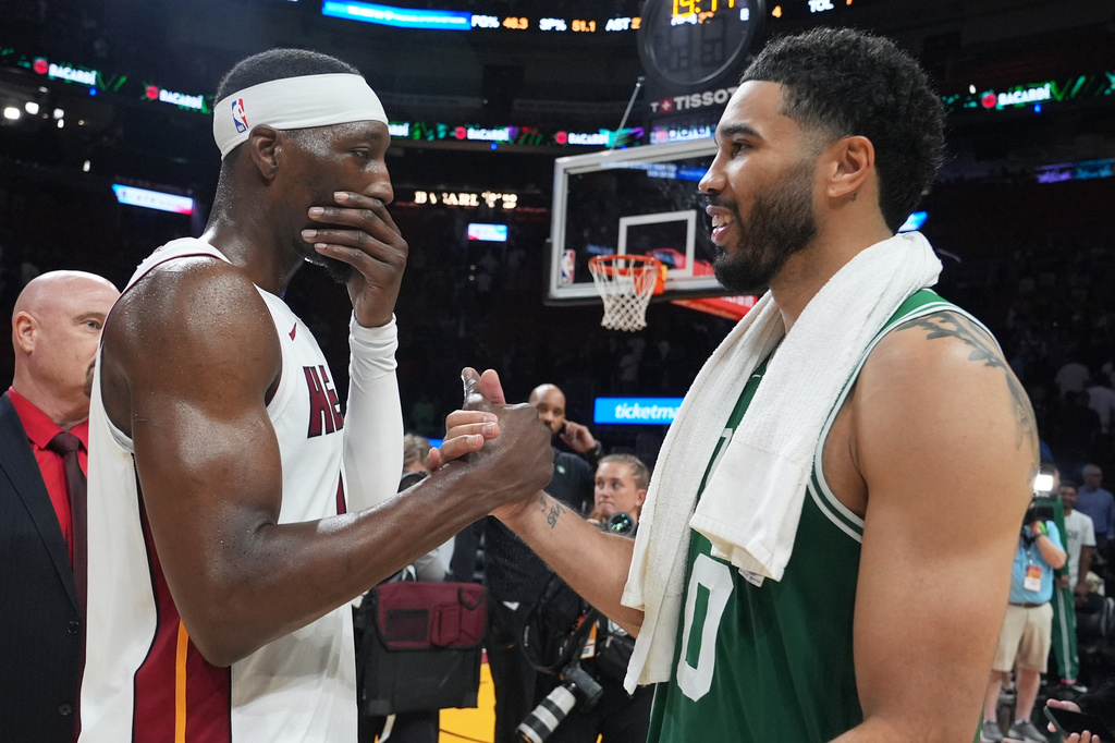 Miami Heat center Bam Adebayo, left, and Boston Celtics forward Jayson Tatum, right, shake hands after an NBA basketball game, Wednesday, April 1, 2026, in Miami. (AP Photo/Lynne Sladky)