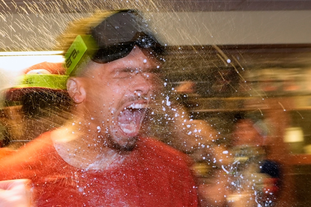 Cincinnati Reds' Chase Burns celebrates after making it into the playoffs after a baseball game against the Milwaukee Brewers Sunday, Sept. 28, 2025, in Milwaukee. (AP Photo/Morry Gash)