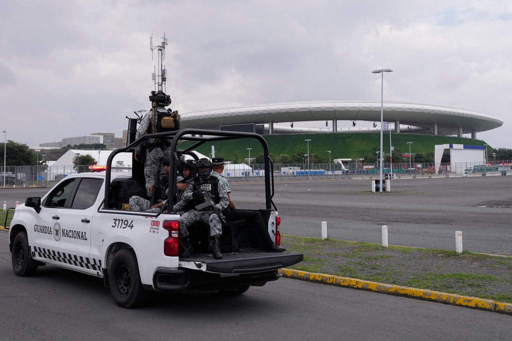 National Guard ride past the stadium that will host FIFA World Cup matches in Guadalajara, Mexico, Tuesday, June 9, 2026. (AP Photo/Matias Delacroix)