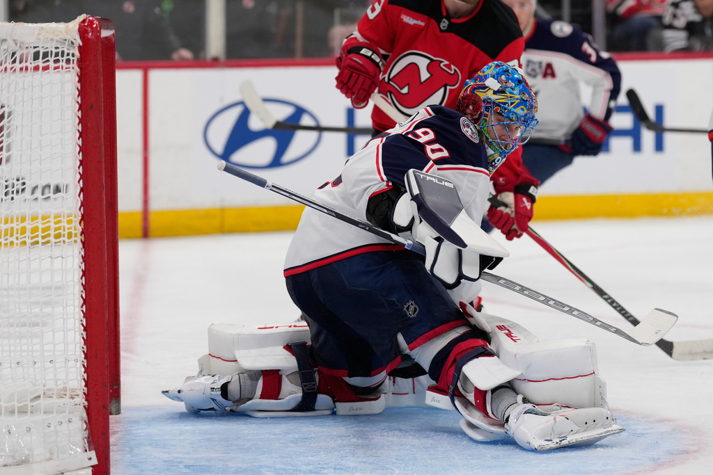 Columbus Blue Jackets goaltender Elvis Merzlikins defends the goal during the second period of an NHL hockey game against the New Jersey Devils in Newark, N.J., Monday, Dec. 1, 2025. (AP Photo/Seth Wenig)