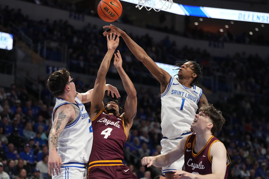 Saint Louis' Quentin Jones (1) knocks the ball away from Loyola Chicago's Kayde Dotson (4) as Saint Louis' Robbie Avila, left, watches during the first half of an NCAA college basketball game Wednesday, March 4, 2026, in St. Louis. (AP Photo/Jeff Roberson)