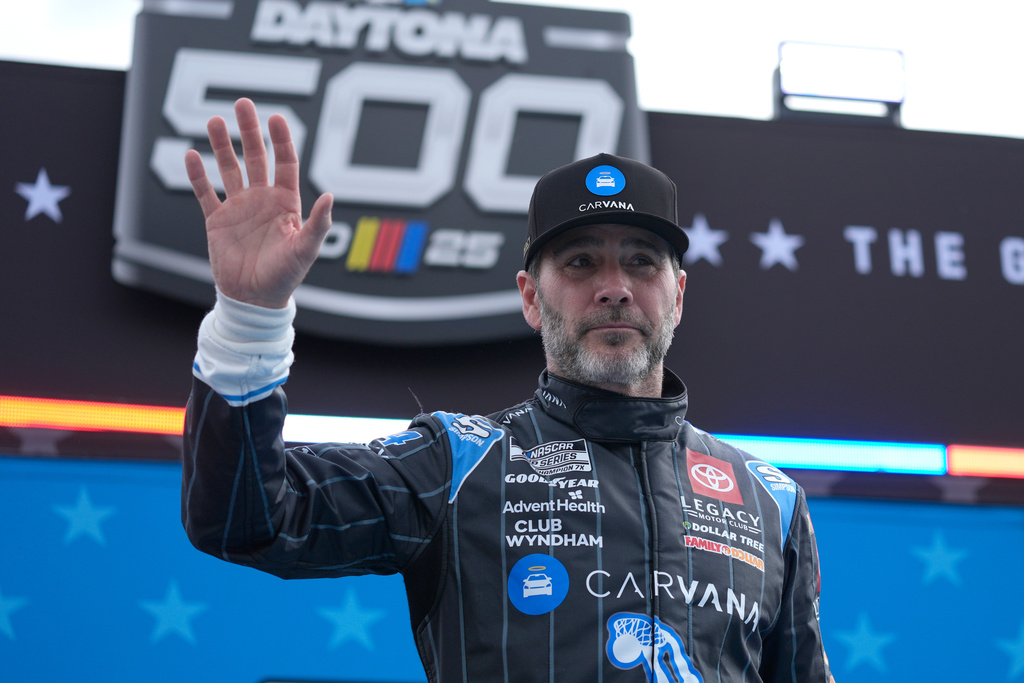 FILE - Jimmie Johnson waves during driver introductions before the NASCAR Daytona 500 auto race at Daytona International Speedway, Feb. 16, 2025, in Daytona Beach, Fla. (AP Photo/John Raoux, File)