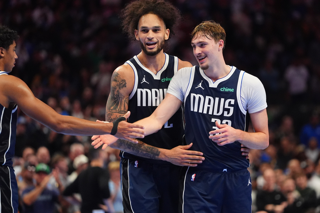 CORRECT PLAYER AT CENTER - Dallas Mavericks forward Cooper Flagg (32) celebrates with teammates guard Max Christie, left, and center Dereck Lively II (2) during the second half of an NBA basketball game against the New Orleans Pelicans in Dallas, Friday, Nov. 21, 2025. (AP Photo/LM Otero)