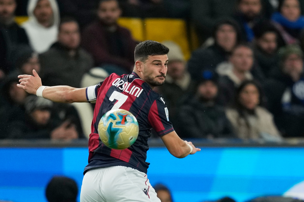 Bologna's Riccardo Orsolini jumps for a header during an Italian Super Cup semi-final soccer match between Bologna and Inter Milan in Riyadh, Saudi Arabia, Friday, Dec. 19, 2025. (AP Photo/Altaf Qadri)