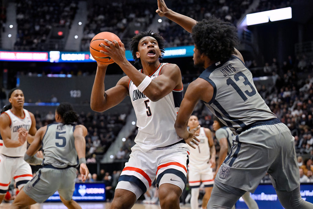UConn forward Tarris Reed Jr. (5) looks to shoot as Butler center Drayton Jones (13) defends in the first half of an NCAA college basketball game, Tuesday, Dec. 16, 2025, in Hartford, Conn. (AP Photo/Jessica Hill)