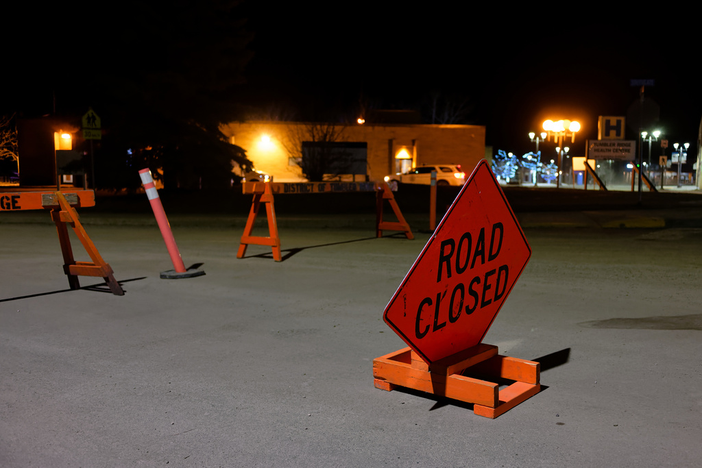 The road is blocked off before the Tumbler Ridge Secondary School, with the Tumbler Ridge Health Centre in the background, in Tumbler Ridge, B.C., Canada, on Wednesday, Feb. 11, 2026. (Jesse Boily/The Canadian Press via AP)