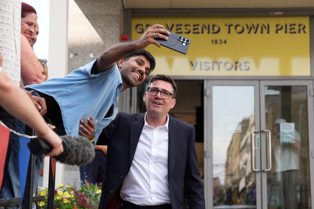 Newly confirmed Labour Party leader Andy Burnham has a selfie taken after speaking with local stakeholders and party supporters during a visit to Gravesend Town Pier, Gravesend , England, Friday July 17, 2026. (Gareth Fuller/PA via AP)