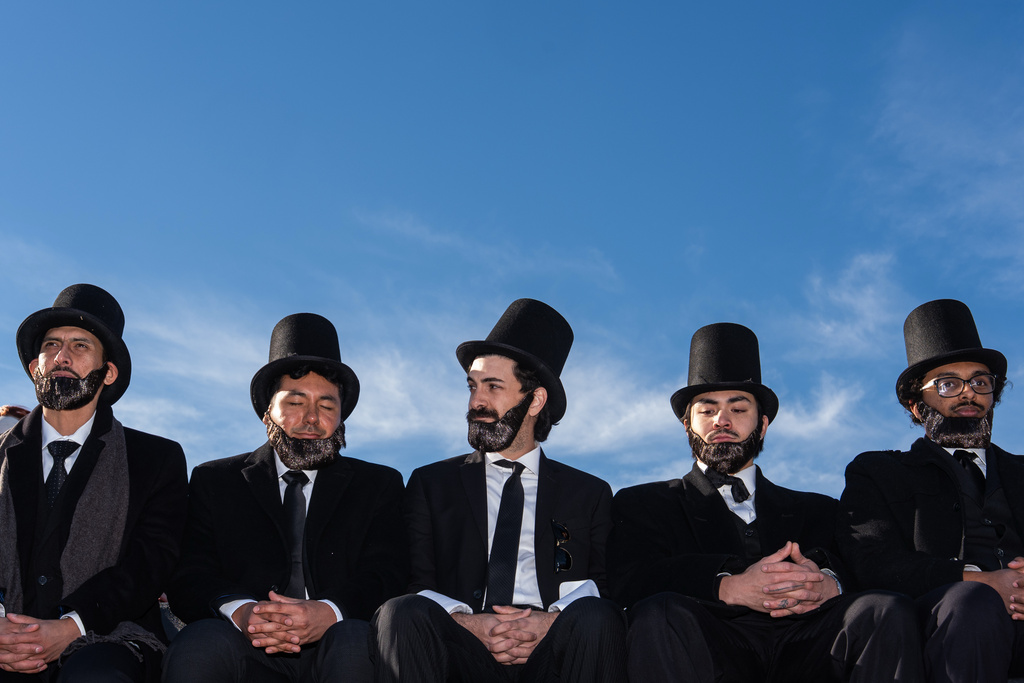 Men dressed as former President Abraham Lincoln attend a mock funeral for the penny, which was discontinued earlier this year, Saturday, Dec. 20, 2025, in front of the Lincoln Memorial in Washington. (AP Photo/Julia Demaree Nikhinson)
