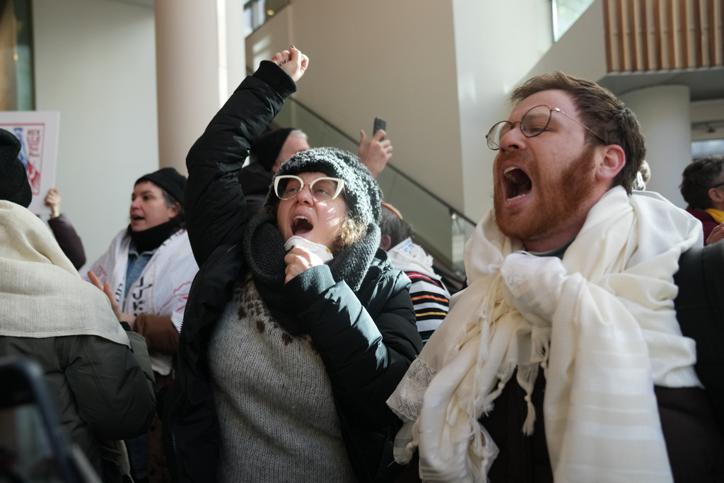 Protesters against Federal immigration agents gather at Target, Friday, Jan. 23, 2026, in Minneapolis. (AP Photo/Abbie Parr)