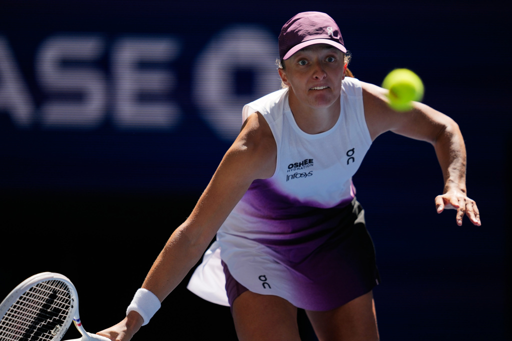 Iga Swiatek, of Poland, returns the ball to Qinwen Zheng, of China, during the fourth round of the U.S. Open tennis championships, Monday, Sept. 7, 2026, in New York. (AP Photo/Seth Wenig)