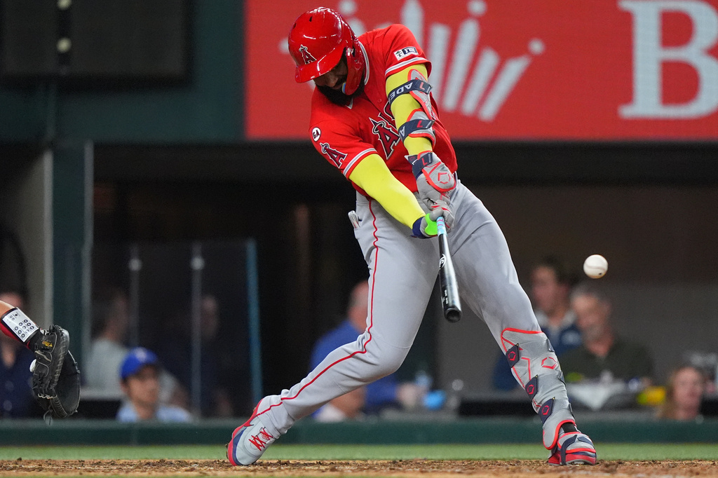 Los Angeles Angels' Jo Adell hits a run scoring single during the seventh inning of a baseball game against the Texas Rangers, Thursday, July 9, 2026, in Arlington, Texas. (AP Photo/LM Otero)