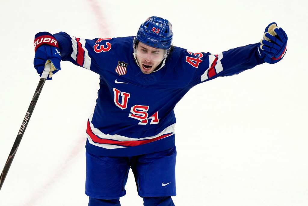 United States' Quinn Hughes celebrates after scoring the winning goal against Sweden during the overtime period of a men's ice hockey quarterfinal game at the 2026 Winter Olympics, in Milan, Italy, Wednesday, Feb. 18, 2026. (AP Photo/Hassan Ammar)