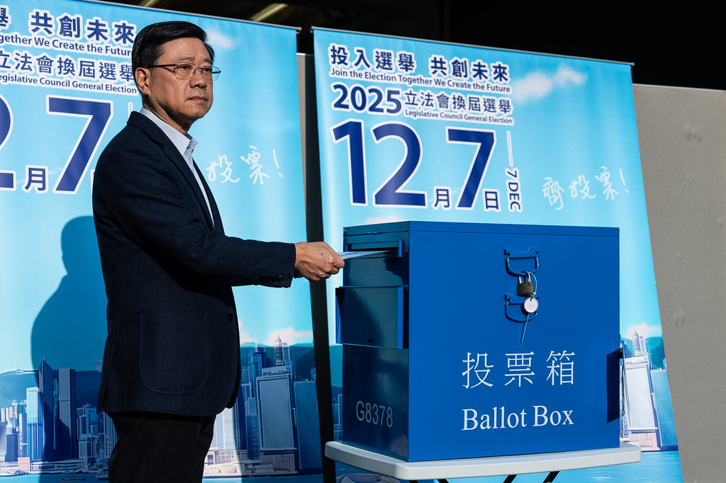 Hong Kong's Chief Executive, John Lee casts his ballot at a polling station during the Legislative Council General Election in Hong Kong on Sunday, Dec. 7, 2025. (AP Photo/Chan Long Hei)