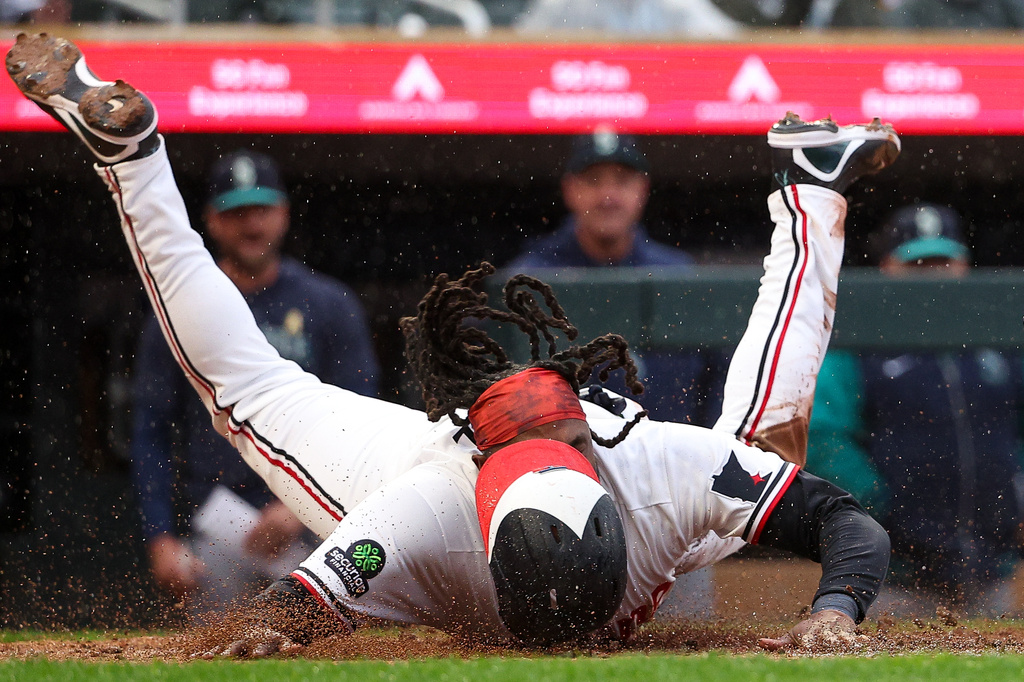 Minnesota Twins designated hitter Josh Bell slides safely into home plate against the Seattle Mariners during the second inning of a baseball game, Monday, April 27, 2026, in Minneapolis. (AP Photo/Matt Krohn)