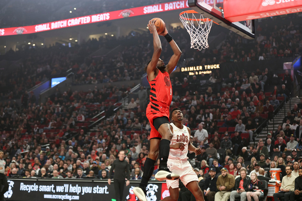 Portland Trail Blazers forward Jerami Grant (9) drives to the basket past Cleveland Cavaliers center Thomas Bryant during the first half of an NBA basketball game, Sunday, Feb. 1, 2026, in Portland, Ore. (AP Photo/Amanda Loman)