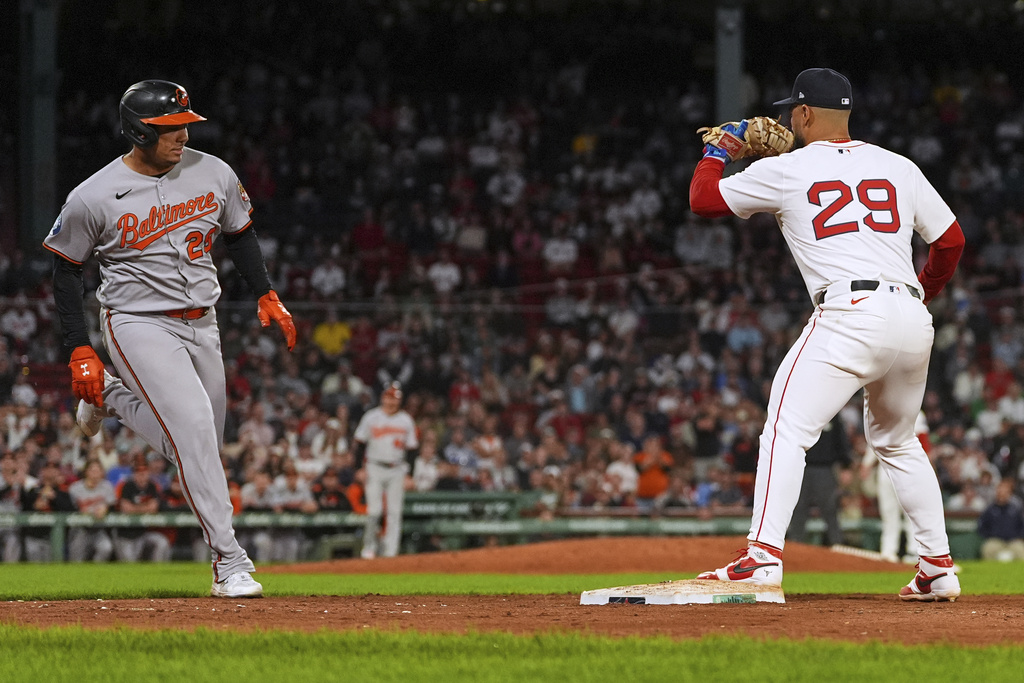 Baltimore Orioles' Samuel Basallo, left, drives home Jeremiah Jackson, breaking a 3-3 tie, as Boston Red Sox first baseman Abraham Toro (29) makes the force out in the eleventh inning of a baseball game at Fenway Park, Tuesday, Aug. 19, 2025, in Boston. (AP Photo/Charles Krupa)
