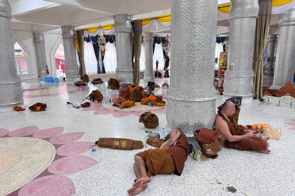 This photograph released by the Phu Manorom temple shows monks who were slightly injured from a crash in Mukdahan province taking rest at Phu Manorom temple in Mukdahan province, Thailand, Thursday, July 2, 2026. (Phu Manorom temple via AP)
