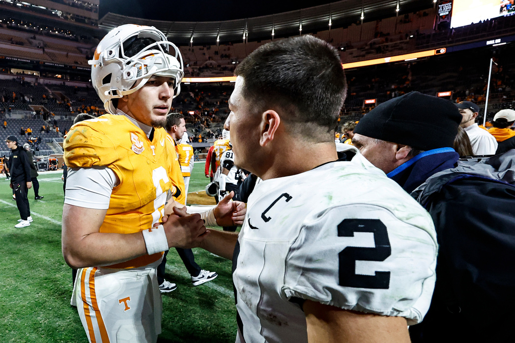 Vanderbilt quarterback Diego Pavia (2) shakes hands with Tennessee quarterback Joey Aguilar (6) after an NCAA college football game Saturday, Nov. 29, 2025, in Knoxville, Tenn. (AP Photo/Wade Payne)