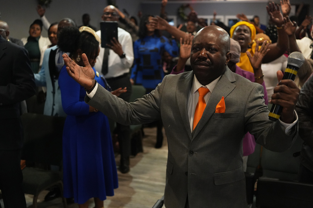 FILE - Rev. Reginald Silencieux, right, leads a worship service at the First Haitian Evangelical Church of Springfield, Feb. 1, 2026, in Springfield, Ohio. (AP Photo/Luis Andres Henao, file)