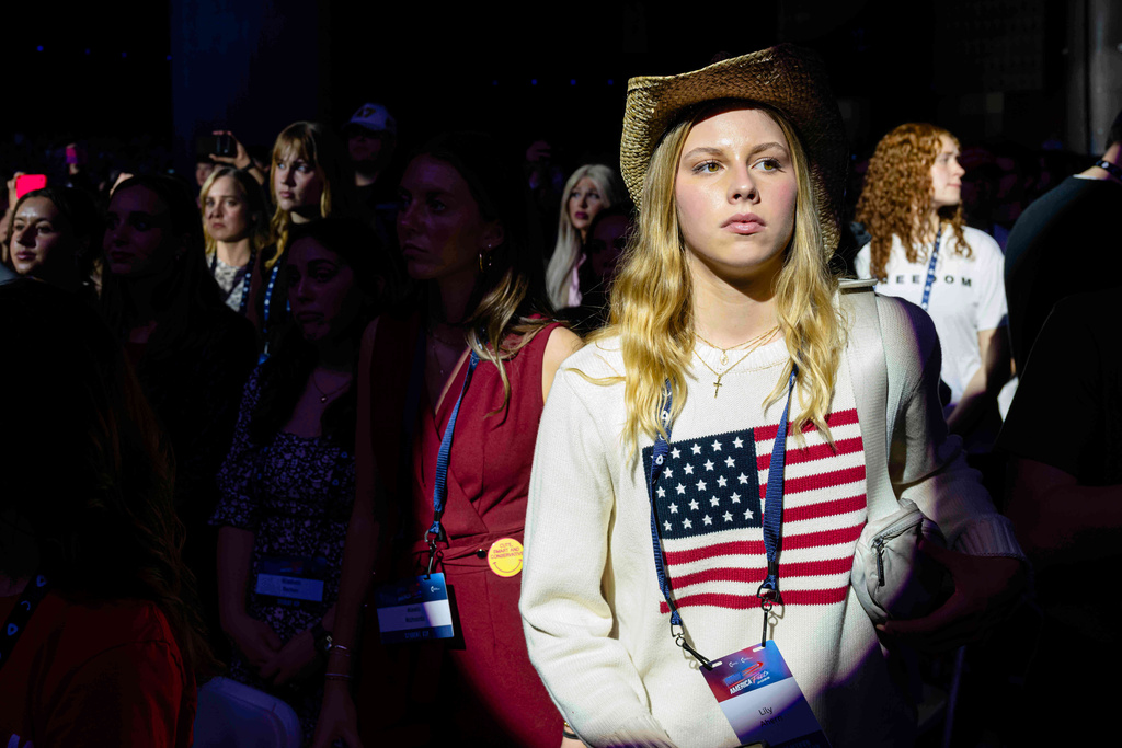 Attendees stand during Turning Point USA's AmericaFest 2025, Thursday, Dec. 18, 2025, in Phoenix. (AP Photo/Jon Cherry)